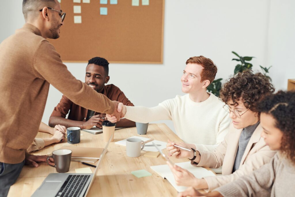 A diverse team in a modern office working together on a project, showcasing teamwork and collaboration.